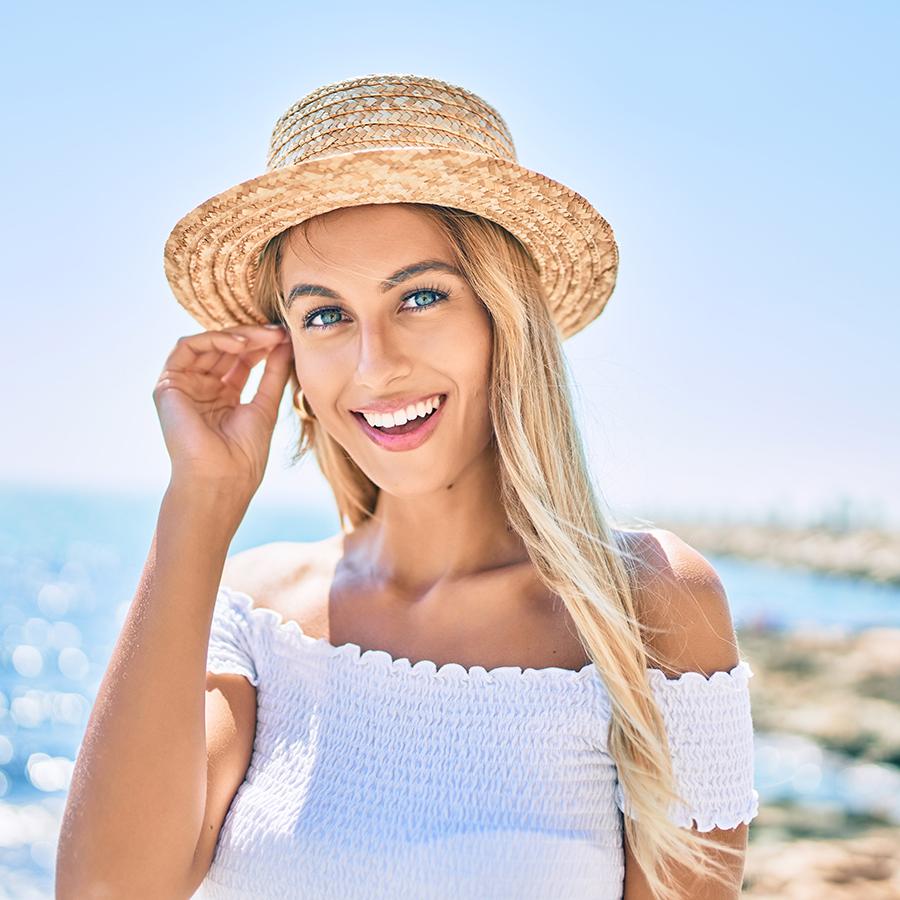 Invisalign dentist in Laguna Beach - Woman on main beach smiling